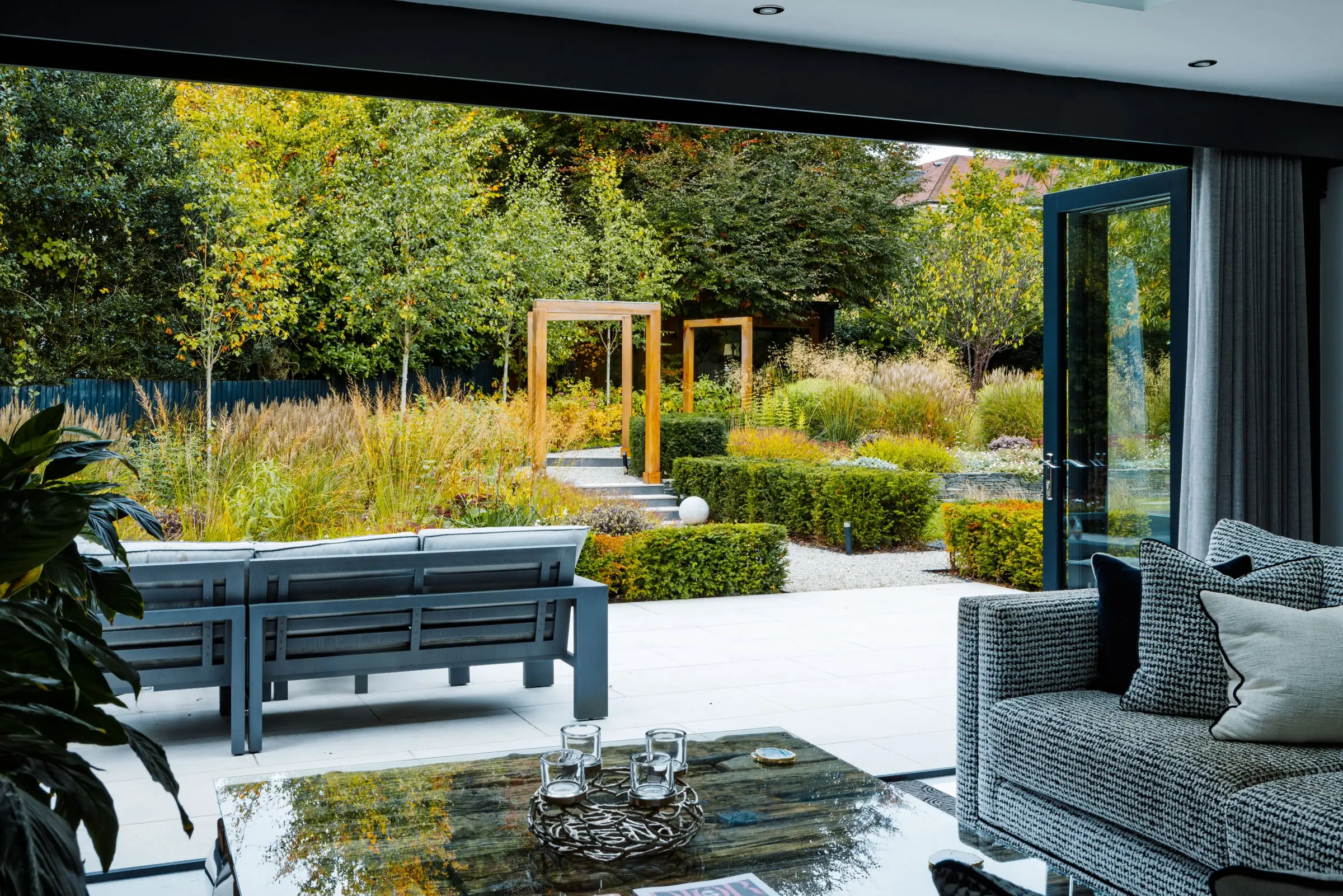 View from a living room out to a richly planted Woburn Sands garden